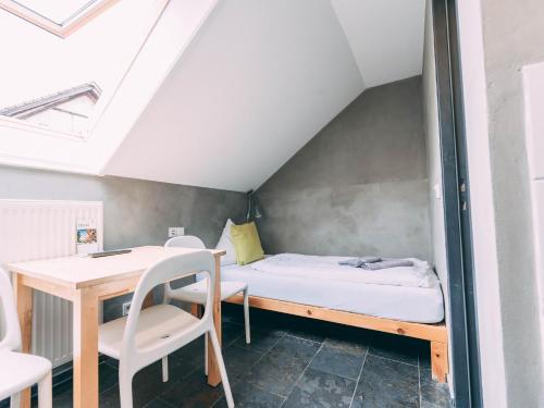a small room with a bed and a desk at Gut Hügle Jugendzimmer in Ravensburg
