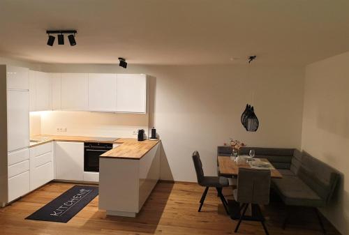 a kitchen and dining room with a table and a table and chairs at Appartement Heimatliebe in Schladming