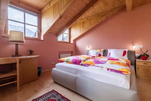 a bedroom with a large bed in a attic at Bbmarlene in Bolzano