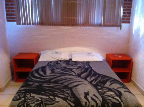 uma cama com um cobertor de zebra num quarto em Hotel Centro Diana em Cidade do México