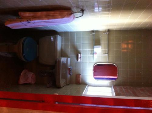 a bathroom with a toilet with a red seat at Hotel Centro Diana in Mexico City