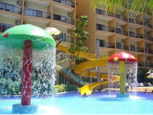 a pool with a water slide in a resort at 3 room apartment with garden view in Banting