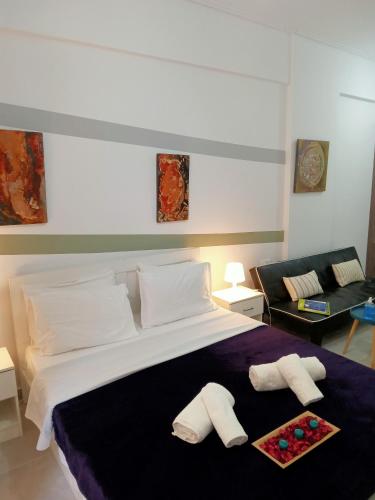 a bedroom with a large bed with two pillows at Cozy spot apt next to metro station . in Athens