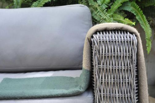 a wicker chair with a rug on top of it at La Maison de Tanger in Tangier