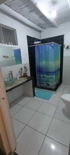a bathroom with a large aquarium in the wall at Casa Blue Hill Beach in Cerro Azul
