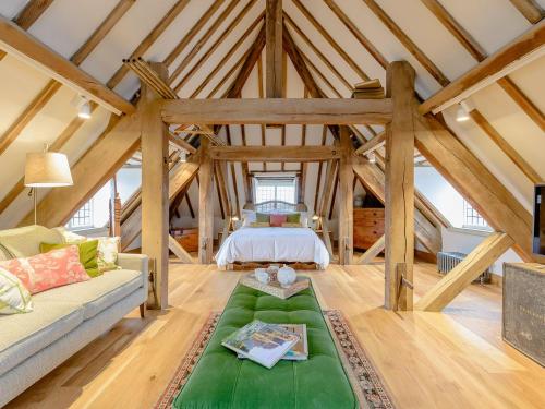 a large room with a bed in a attic at The Loft At Brackley Town Hall in Brackley