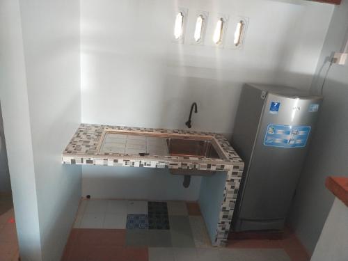 a lego kitchen with a sink and a refrigerator at Homestay Pak Ucu 