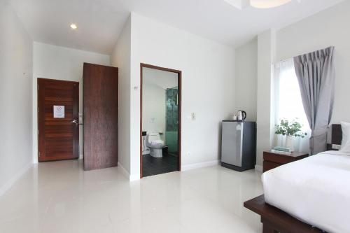 Postel nebo postele na pokoji v ubytování The Langstan Suites