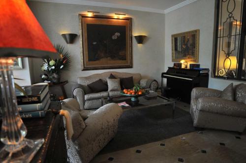 a living room with couches and a piano at La Maison de Tanger in Tangier