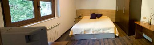 a small bedroom with a bed and a tv at Casa Buda Conors & Spa in Foz