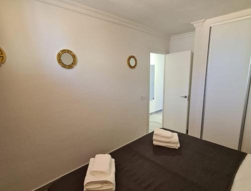 a room with a mirror and a table with towels at The SunSpot Apartment Playa del Inglés in Maspalomas