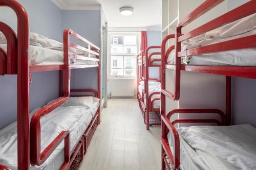 a group of bunk beds in a room at Astor Victoria Hostel in London