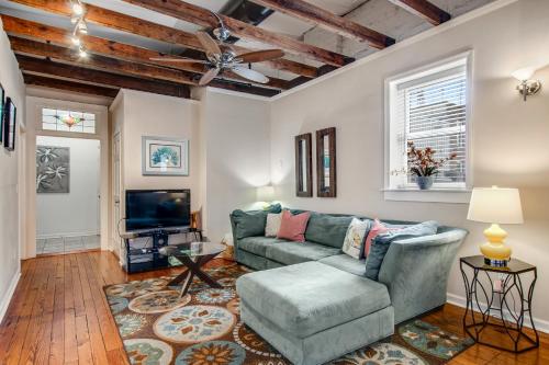 a living room with a couch and a tv at Historic City Market - Loft Off Broughton Too in Savannah