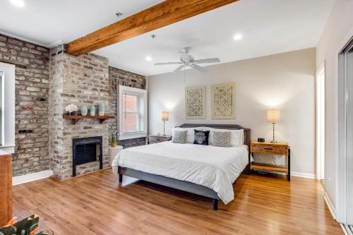 a bedroom with a bed and a brick wall at Historic City Market - Loft Off Broughton Too in Savannah