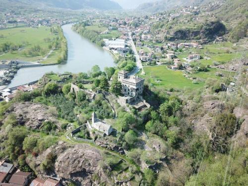 an aerial view of a town next to a river at Romantic Italian Castle at the foot of the Alps in Settimo Vittone