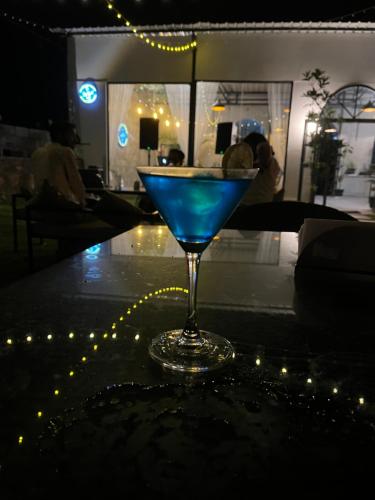 a blue drink sitting on top of a table at The Offbeat Lounge in Udaipur