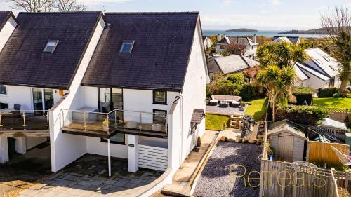 an aerial view of a white house with a balcony at Min Y Don in Abersoch