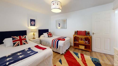 a bedroom with two beds with american flags at Min Y Don in Abersoch