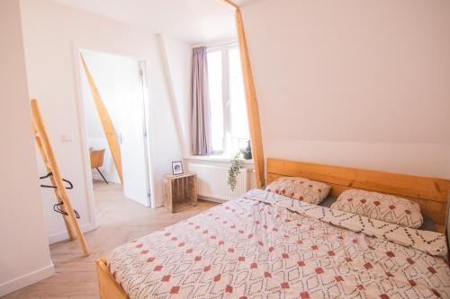 a bedroom with a bed with a wooden bed frame at Appartement in binnenstad/centrum van Leeuwarden in Leeuwarden