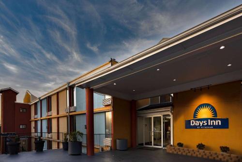 a day inn sign on the side of a building at Days Inn by Wyndham Hartsfield Jackson Atlanta Airport West in Atlanta