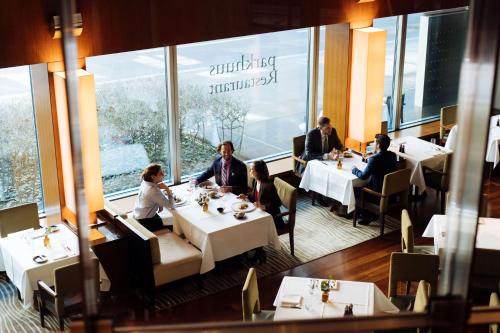 people sitting at a table in a restaurant at Park Hyatt Zurich – City Center Luxury in Zurich