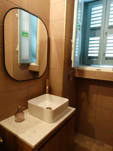 a bathroom with a sink and a mirror at 60 Indri Borg Townhouse in Rabat