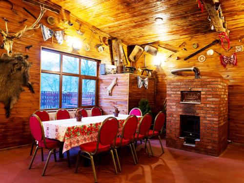 a dining room with a table and chairs and a fireplace at Casa Pedro in Blăjani