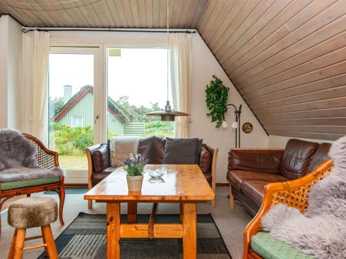 a living room with a couch and a table at 6 person holiday home in Hvide Sande in Hvide Sande