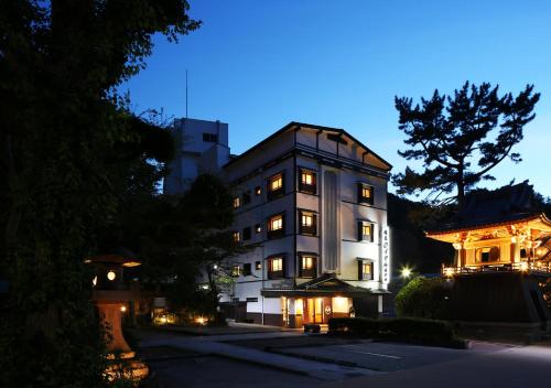 a large white building at night with a building at Arima Royal Hotel in Kobe