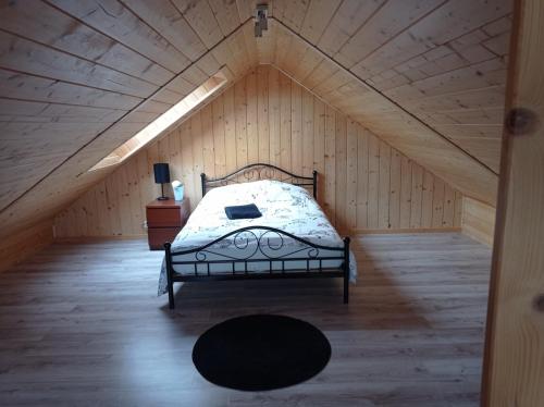 a bedroom with a bed in a attic at apartamentyDvorskie in Nowy Sącz