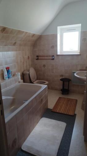 La salle de bains est pourvue d'une grande baignoire et d'un lavabo. dans l'établissement La Bretagne ça vous gagne, à Ploufragan