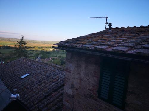 an old brick building with a roof with a view at Antico Borgo di Torri in Sovicille