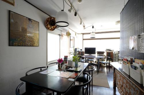 a dining room with a table and some chairs at Sapporo Inn Nada in Sapporo
