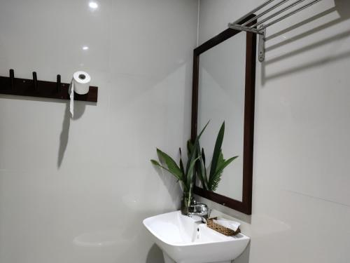 a white bathroom with a sink and a mirror at Banyan Villa Nha Trang in Nha Trang