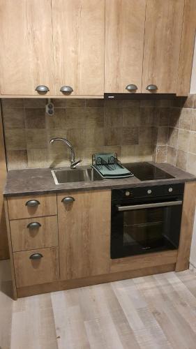 a kitchen with a sink and a stove at Larry's little place in the center of Gytheio in Gythio