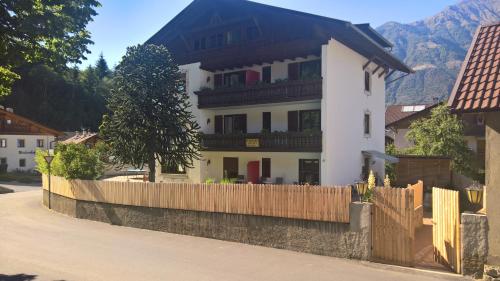 a white house with a wooden fence in front of it at Hotel Krone in Morter