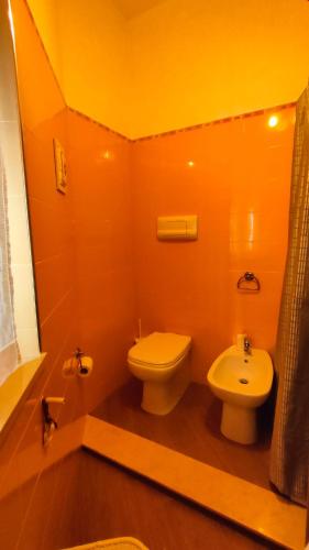 a bathroom with a white toilet and a sink at CASA SOPRANO da Anita in Messina