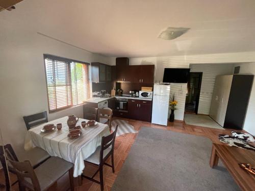 a kitchen and dining room with a table and chairs at PANTELI APART HOUSE in Aheloy