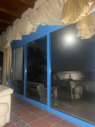 a room with a large glass window with a couch at Minoan house in Tsoutsouros