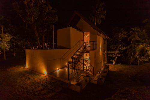a house with a staircase illuminated at night at Serendipity Lake - Hikkaduwa in Hikkaduwa