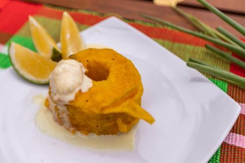 a doughnut with ice cream and orange slices on a white plate at Serendipity Lake - Hikkaduwa in Hikkaduwa