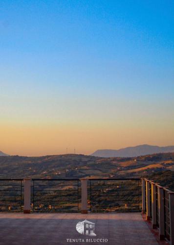 a view of the hills from a balcony at sunset at TENUTA BILUCCIO B & B in Roccadaspide