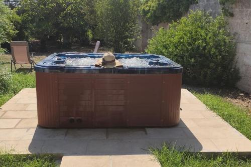 a person in a hat sitting in a hot tub at Seaside Villa with Hot Tub, 5mins walk from the sea in Torre rinalda