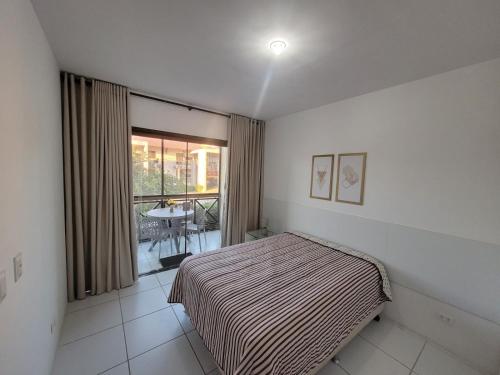 a bedroom with a bed and a large window at Flat Studio 11 Hotel Fazenda Gravatá-PE in Gravatá