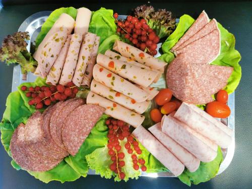 a plate of food with meat and vegetables on it at Akteon Hotel in Stuttgart