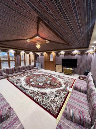 a large room with a large rug on the floor at Al Shiya Chalet in Sur