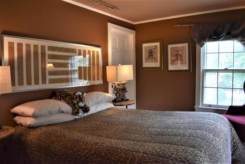 a bedroom with a large bed and a window at Admiral Peary Inn in Fryeburg