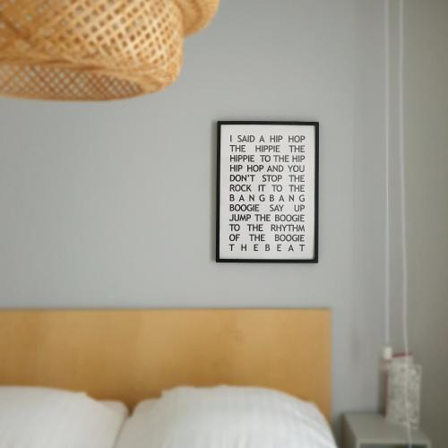 a bedroom with a bed and a calendar on the wall at Sonnevanck Wijk aan Zee in Wijk aan Zee