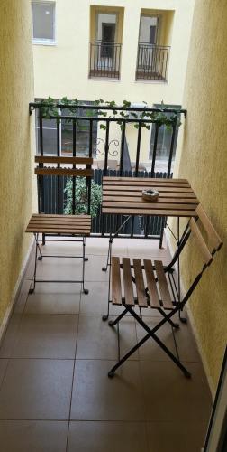 a balcony with two benches and a table at Siriului Studio in Bucharest