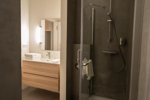 a bathroom with a shower with a glass door at The Layhead B&B in Lübeck